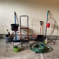 Front view of entire lot showing all garden tools, hose, planters, dolly, lantern