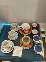 All mugs, cups and saucers grouped on table