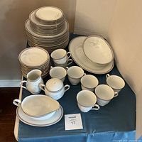 Full lot showing stacked plates, cups, serving pieces