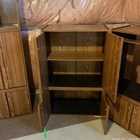 Cabinet lower doors open showing interior shelves