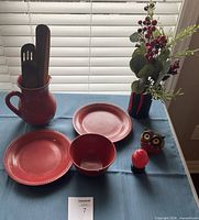 Overall view: pitcher with utensils, two plates, bowl, shaker, owl figurine, floral arrangement