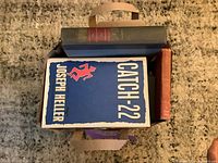Bag of books top view with Catch-22 and other hardcovers visible