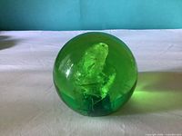 Overall view of green Lucite sphere paperweight showing internal lacy pillars