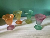 Four frosted parfait glasses upright, showing colors and tulip rims