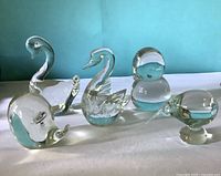 Group of five clear glass animal paperweights