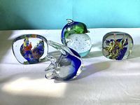 Group shot of all four art glass paperweights