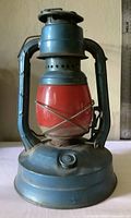 Full front view showing blue frame, red globe, fuel cap, overall structure