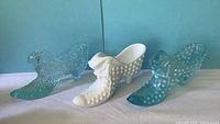 Front view of three glass slipper figurines