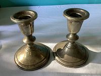 Front view of both Towle candlesticks showing overall form and patina