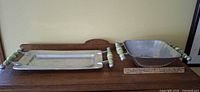Both serving pieces on table with ruler for scale