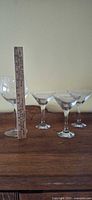 Group view of 3 martini glasses, 1 wine glass, ruler for scale