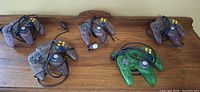 Five translucent third-party N64 controllers on table
