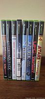 Front spines of all eight Xbox game cases showing titles
