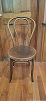 Full view of bentwood chair front on wood floor