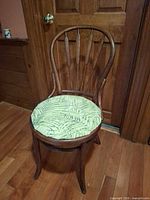 Full view of chair showing bentwood frame, backrest design and seat cushion