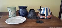 Group view of six candle accessories on table