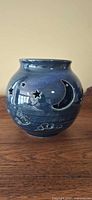 Full view of blue ceramic candle holder showing celestial cut-outs