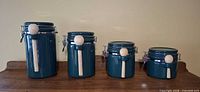 Front view of all four ceramic canisters lined up from tallest to shortest