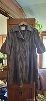 Front view of gray crinkle jacket on hanger showing collar, buttons, puff sleeves