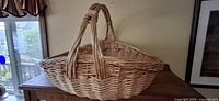 Side view of large wicker basket on table