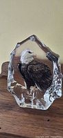 Front view of crystal paperweight showing bald eagle design