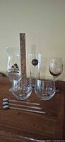 Group shot of all glasses and stirrers with ruler for scale