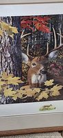 Close view of print showing buck, autumn leaves and tree trunk