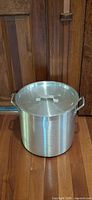 Exterior view of aluminum pot with lid and handles