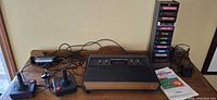 Console, two joysticks, cartridge tower, cords, manual