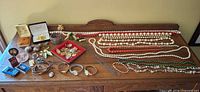 Overall view of assorted jewelry and watches on wooden surface