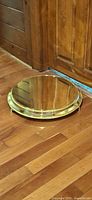 Full view of gold metal cake stand on floor