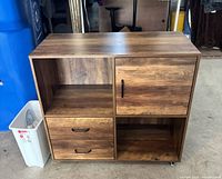 Front view showing drawers, open shelf, door and overall finish