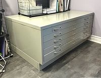 Front view showing five drawers with handles and label holders