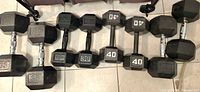 Lineup of all eight dumbbells showing weight markings 30-45 lb