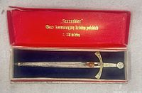 Miniature sword in open red box showing full view