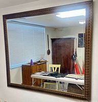 Front view showing full mirror and decorative frame