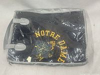Blanket in original packaging showing Notre Dame lettering and Oarsman branding