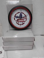 Clock with flag leaf design on top of stacked white boxes