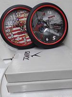 Overall view showing both clocks resting on two branded CANV boxes