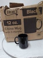 Cardboard Choice brand box labeled 12 oz China Mug with C-Handle alongside one representative black mug