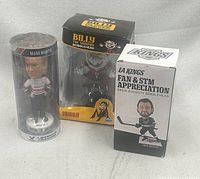 All three bobbleheads in original packaging: Drew Doughty box, Mark Martin tube, Billy the Vampire box