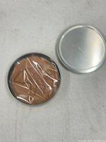 Tin opened showing sealed dalgona cookie