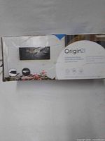 Retail box showing Origin21 black satin wall-mount mailbox
