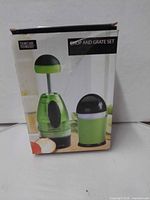 Front of retail box showing chopper and grater images and branding