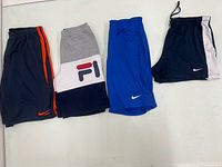 Four pairs: two Nike navy variants, one Fila colour-block, one royal blue Nike