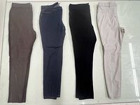 Four visible pairs women’s pants in taupe, navy, black, beige