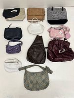 Group shot of all visible handbags laid out on floor