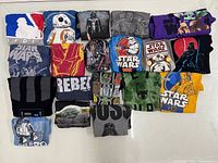 All 19 folded Star Wars T-shirts laid out for overview