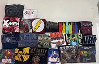 Full layout showing all 20 folded Marvel graphic T-shirts