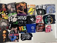 Overall view of 21 folded graphic T-shirts